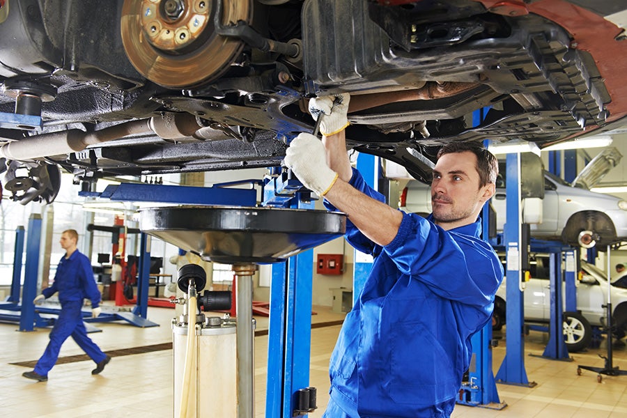 mechanic changing oil at the Criswell Chevrolet GMC of Gaithersburg dealership